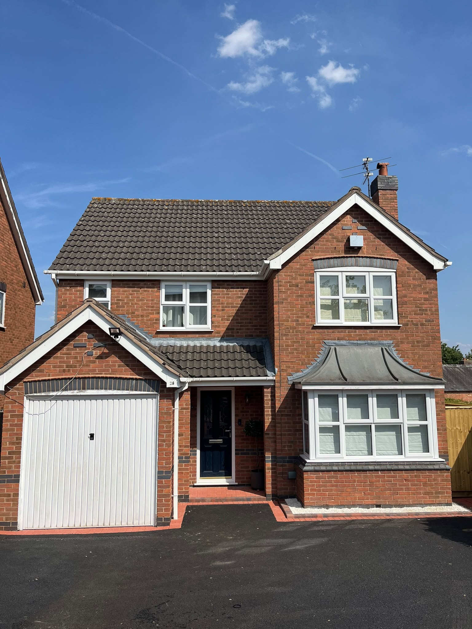 Detached house exterior with sparkling clean windows and frames